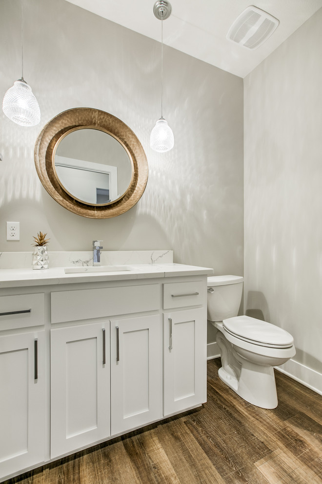 Scandi family bathroom in Omaha with shaker cabinets, white cabinets, a shower/bath combination, a two-piece toilet, a submerged sink, quartz worktops, a shower curtain and an alcove bath.