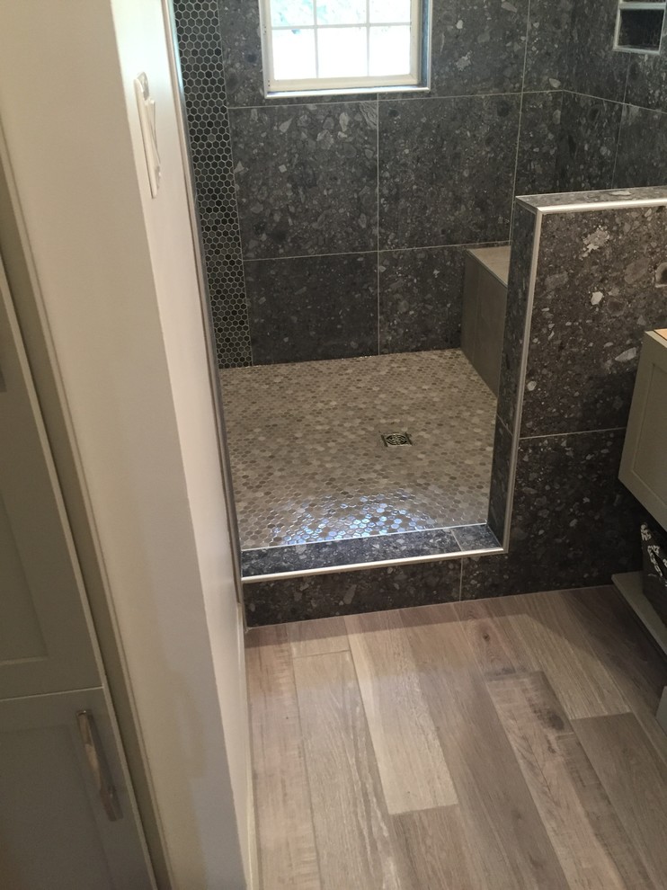 Photo of a large classic ensuite bathroom in Calgary with a walk-in shower, black tiles, porcelain tiles and beige walls.
