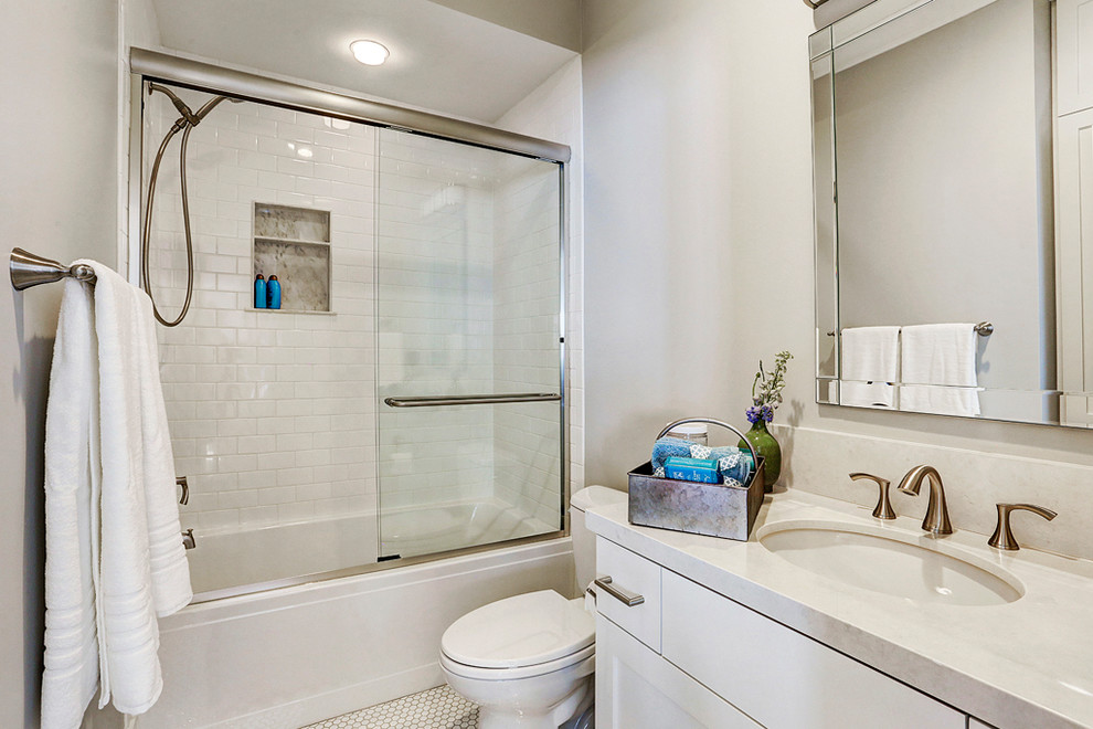 Bathroom - mid-sized transitional 3/4 white tile and subway tile porcelain tile and white floor bathroom idea in Houston with shaker cabinets, white cabinets, a two-piece toilet, gray walls, an undermount sink and quartz countertops
