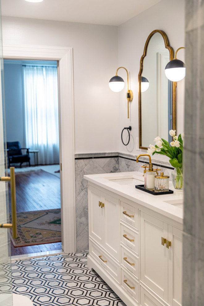 This is an example of a traditional ensuite bathroom in Baltimore with beaded cabinets, white cabinets, an alcove shower, marble tiles, marble flooring, a hinged door, white worktops, a shower bench, double sinks, a freestanding vanity unit and wainscoting.