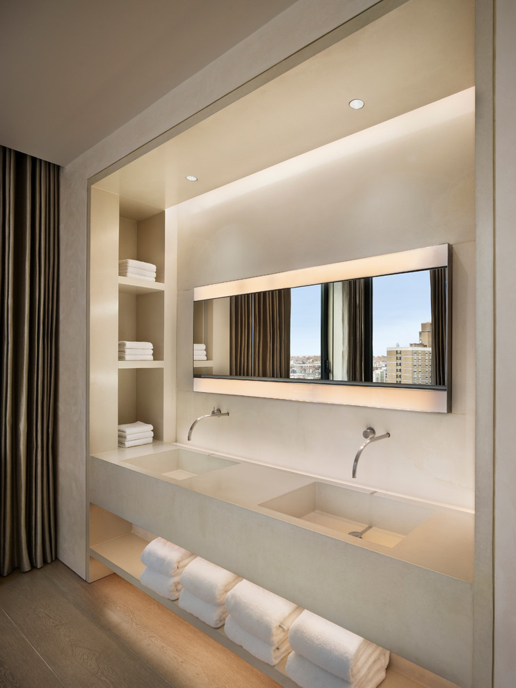 Diseño de cuarto de baño contemporáneo con lavabo integrado y encimera de cemento