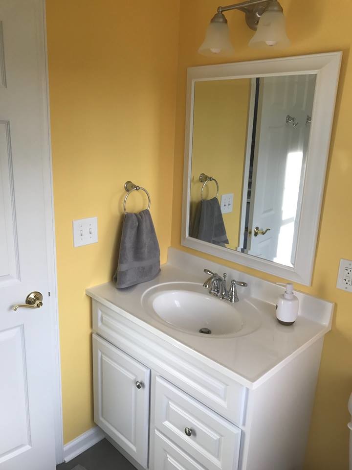 Medium sized classic shower room bathroom in Philadelphia with raised-panel cabinets, white cabinets, an alcove shower, a two-piece toilet, grey tiles, slate tiles, yellow walls, slate flooring, an integrated sink, grey floors and a hinged door.