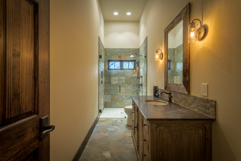 Alcove shower - huge rustic 3/4 beige tile and stone tile slate floor alcove shower idea in Charlotte with an undermount sink, raised-panel cabinets, beige cabinets, granite countertops, a two-piece toilet and beige walls