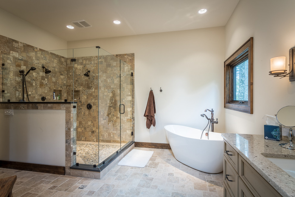Huge mountain style master beige tile and stone tile bathroom photo in Charlotte with an undermount sink, recessed-panel cabinets, beige cabinets, granite countertops, a two-piece toilet and white walls