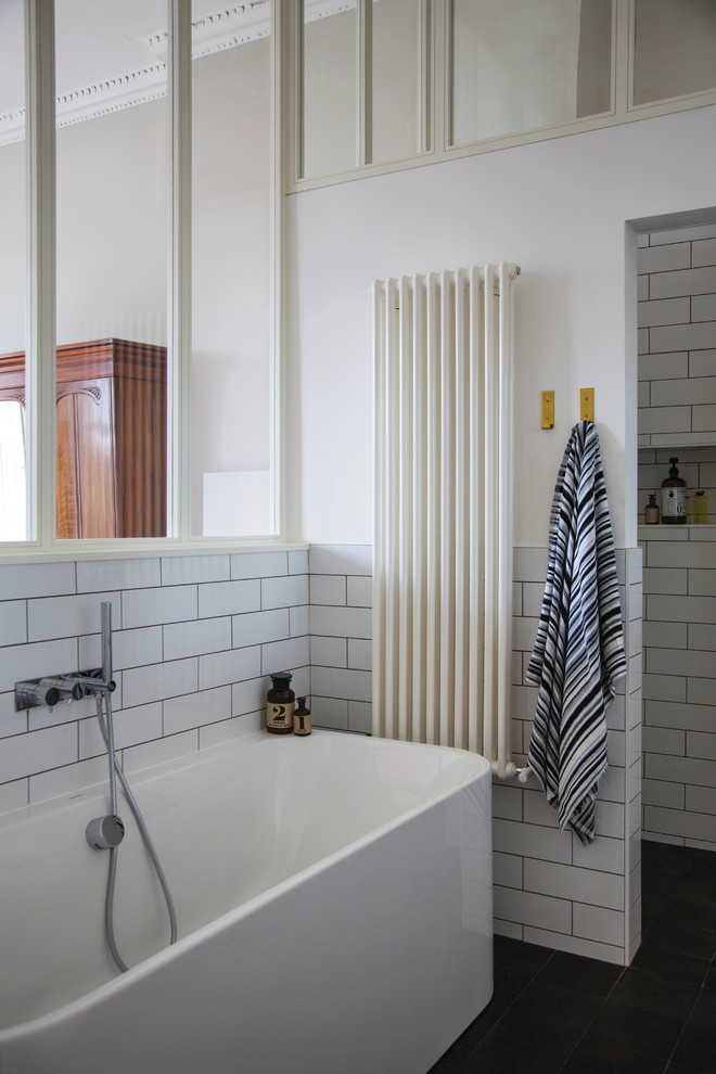 Mittelgroßes Modernes Badezimmer En Suite mit freistehender Badewanne, offener Dusche, weißen Fliesen, Keramikfliesen, weißer Wandfarbe und Betonboden in Dublin