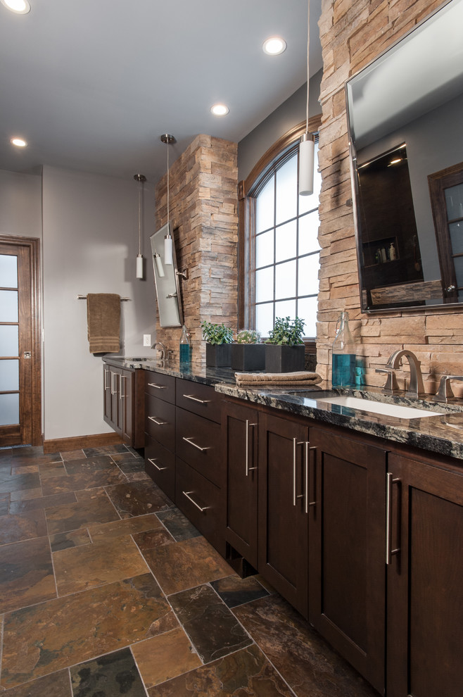 Example of a large transitional master multicolored tile and stone tile slate floor alcove shower design in St Louis with an undermount sink, shaker cabinets, dark wood cabinets, granite countertops and gray walls