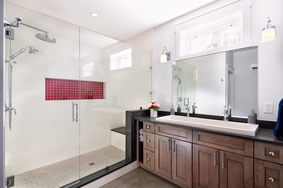 Example of a mid-sized transitional 3/4 multicolored tile and ceramic tile concrete floor and gray floor bathroom design in Denver with shaker cabinets, medium tone wood cabinets, white walls, a trough sink, quartz countertops and a hinged shower door