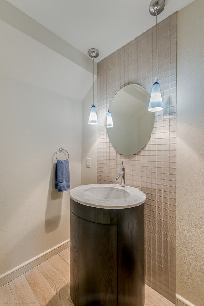 Idee per una piccola stanza da bagno contemporanea con lavabo sottopiano, ante lisce, ante in legno bruno, top in marmo, piastrelle beige, parquet chiaro e pareti beige