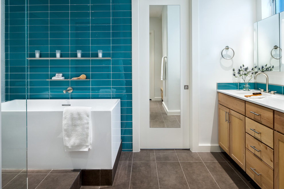 Cette photo montre une salle de bain principale tendance en bois brun de taille moyenne avec un placard à porte shaker, une baignoire indépendante, une douche ouverte, un carrelage bleu, un carrelage en pâte de verre, un mur bleu, un sol en carrelage de céramique, un lavabo encastré et un plan de toilette en quartz modifié.