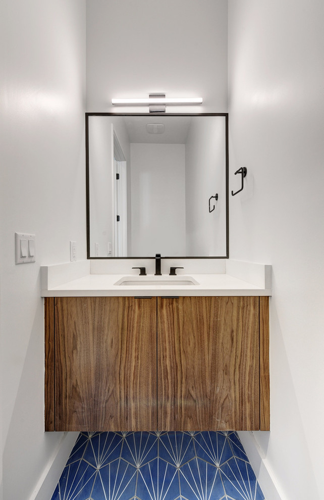 This is an example of a small modern cloakroom in Austin with flat-panel cabinets, dark wood cabinets, white tiles, white walls, cement flooring, quartz worktops, blue floors and a submerged sink.