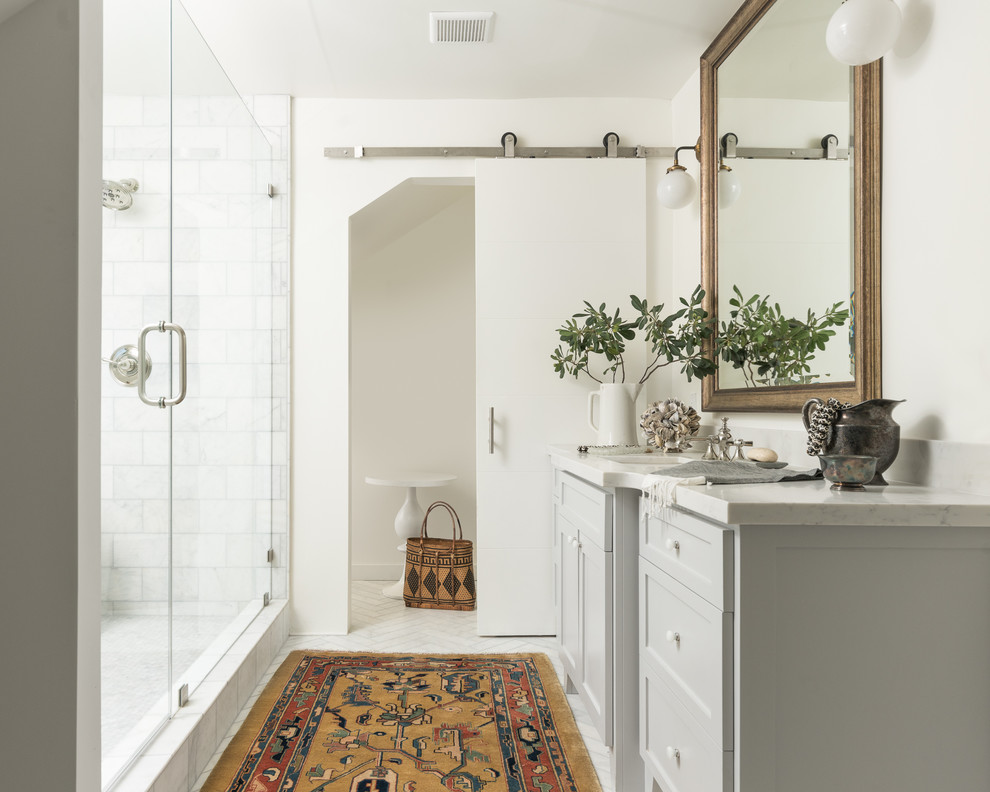 Photo of a medium sized ensuite bathroom in Sacramento with shaker cabinets, grey cabinets, a walk-in shower, stone slabs, white walls, marble flooring, a submerged sink, quartz worktops, white tiles, white floors and a hinged door.