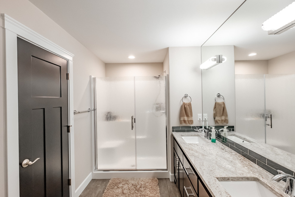 This is an example of a contemporary ensuite bathroom in Portland with an alcove shower, black tiles, beige walls, a submerged sink, granite worktops, a sliding door, beige worktops, shaker cabinets, dark wood cabinets and metro tiles.