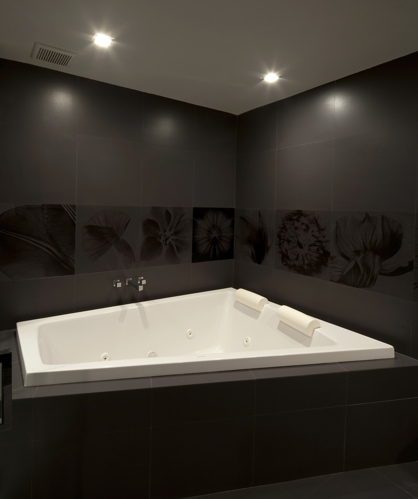 Example of a large eclectic master black tile and ceramic tile ceramic tile bathroom design in Other with a one-piece toilet, an integrated sink and black walls