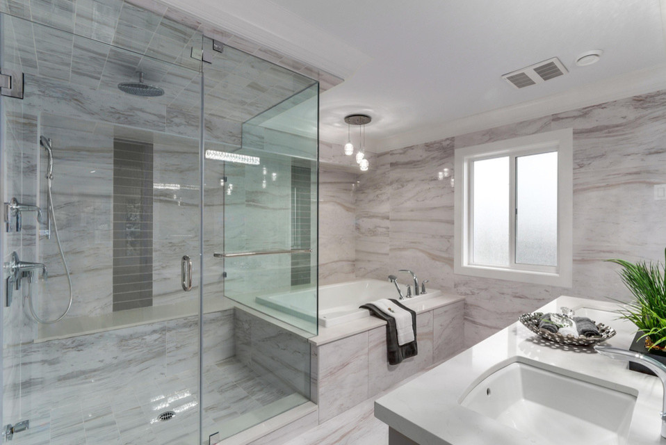Inspiration for a large classic ensuite bathroom in Vancouver with white cabinets, a built-in bath, a corner shower, a two-piece toilet, grey tiles, white tiles, stone slabs, grey walls, marble flooring, a submerged sink and engineered stone worktops.