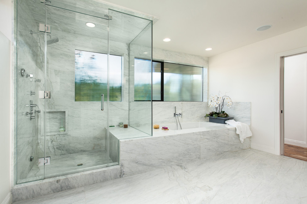 Large contemporary ensuite bathroom in Los Angeles with flat-panel cabinets, light wood cabinets, a submerged bath, a corner shower, a two-piece toilet, white tiles, marble tiles, white walls, marble flooring, a submerged sink, marble worktops, white floors and a hinged door.