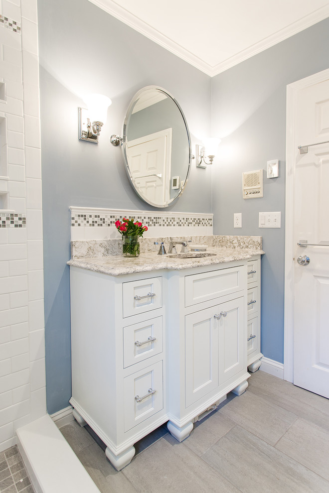 Photo of a medium sized classic shower room bathroom in Boston with shaker cabinets, white cabinets, a walk-in shower, a two-piece toilet, beige tiles, mosaic tiles, grey walls, vinyl flooring, a submerged sink and granite worktops.