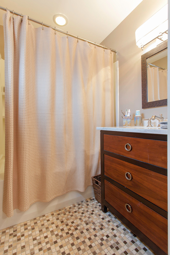 Example of a mid-sized arts and crafts kids' mosaic tile floor alcove shower design in Boston with medium tone wood cabinets, beige walls, an undermount sink and solid surface countertops