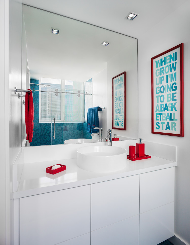 Mid-sized minimalist kids' corner shower photo in Miami with flat-panel cabinets, white cabinets, a one-piece toilet, white walls, a vessel sink and solid surface countertops