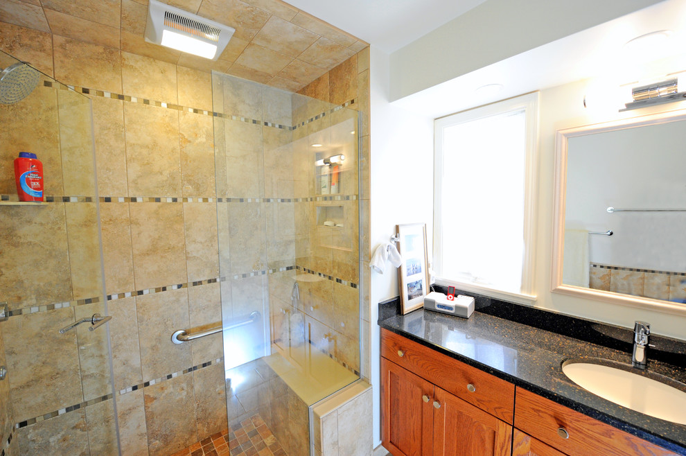 Inspiration for a mid-sized timeless beige tile and porcelain tile porcelain tile alcove shower remodel in Cleveland with an undermount sink, shaker cabinets, medium tone wood cabinets, granite countertops, a two-piece toilet and white walls