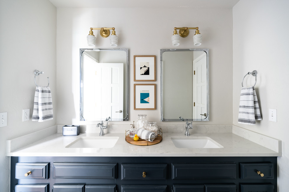 Classic bathroom in Oklahoma City with raised-panel cabinets, blue cabinets, white walls, a submerged sink and white worktops.