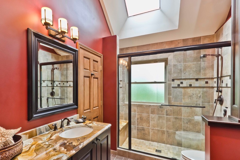 Medium sized traditional family bathroom in Chicago with a submerged sink, raised-panel cabinets, dark wood cabinets, marble worktops, an alcove shower, beige tiles, porcelain tiles, red walls and porcelain flooring.