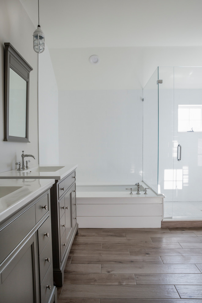 Photo of a large coastal family bathroom in Other with grey cabinets, a built-in bath, a built-in shower, cement tiles, grey walls, porcelain flooring, engineered stone worktops, grey floors, a hinged door, white worktops and shaker cabinets.