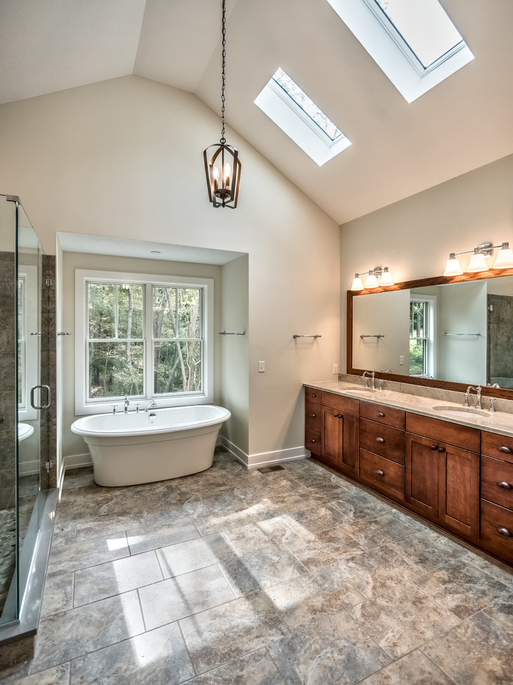 Bathroom - large craftsman master gray tile and ceramic tile ceramic tile and gray floor bathroom idea in Other with shaker cabinets, an undermount sink, a hinged shower door, dark wood cabinets, a two-piece toilet, gray walls and quartzite countertops