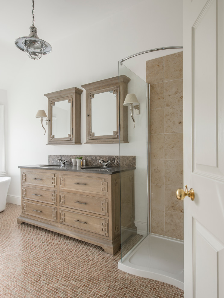 Corner shower - mid-sized traditional master beige tile and ceramic tile mosaic tile floor corner shower idea in Dublin with an undermount sink, furniture-like cabinets, distressed cabinets, solid surface countertops and white walls