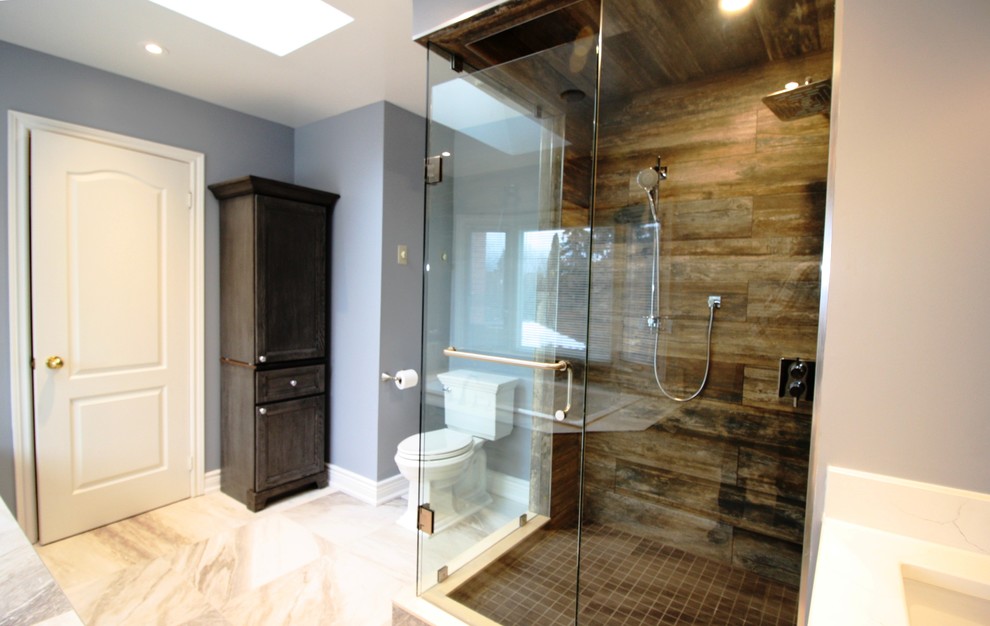 Inspiration for a large modern ensuite bathroom in Toronto with a built-in bath, a double shower, a one-piece toilet, blue walls, beige floors, a hinged door, recessed-panel cabinets, dark wood cabinets, a submerged sink and white worktops.