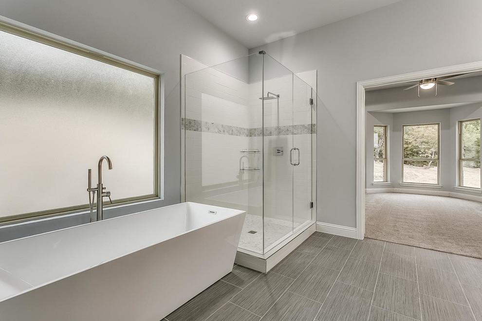 Example of a mid-sized minimalist master white tile and porcelain tile porcelain tile and gray floor bathroom design in Dallas with shaker cabinets, gray cabinets, a one-piece toilet, gray walls, an undermount sink, solid surface countertops, a hinged shower door and white countertops
