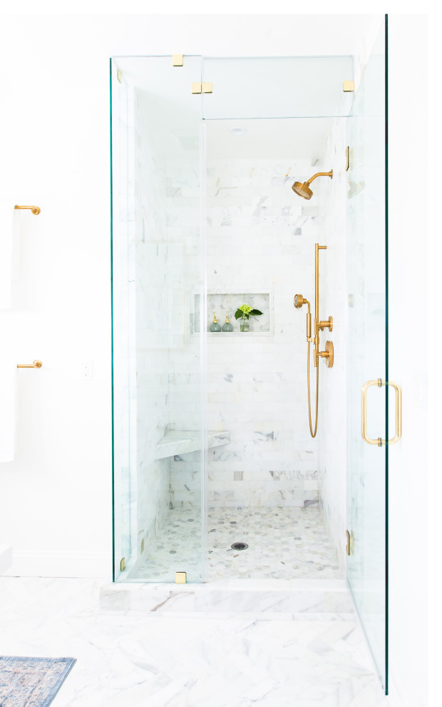 Идея дизайна: главная ванная комната в стиле неоклассика (современная классика) с белыми фасадами, белой плиткой, мраморной плиткой, мраморным полом, врезной раковиной, столешницей из искусственного кварца, желтым полом, душем с распашными дверями и белой столешницей