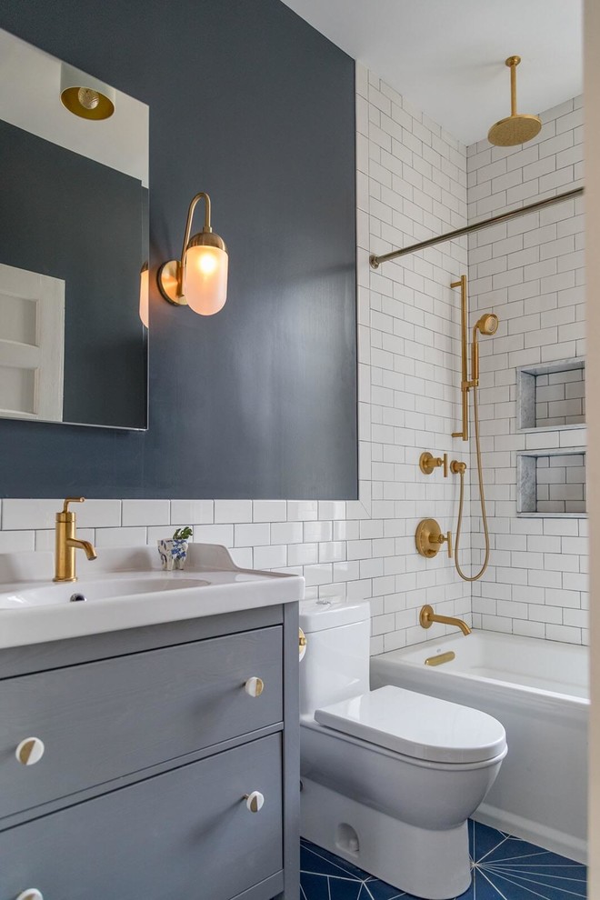 ニューヨークにあるトランジショナルスタイルのおしゃれなバスルーム (浴槽なし) (グレーのキャビネット、アルコーブ型浴槽、シャワー付き浴槽	、白いタイル、サブウェイタイル、グレーの壁、一体型シンク、青い床、フラットパネル扉のキャビネット) の写真