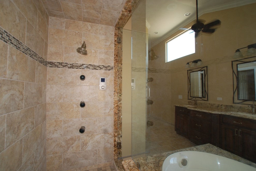 Inspiration for a huge timeless master beige tile and porcelain tile porcelain tile bathroom remodel in Orange County with an undermount sink, raised-panel cabinets, distressed cabinets, granite countertops, a two-piece toilet and beige walls