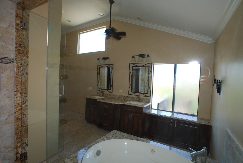 Huge elegant master beige tile and porcelain tile porcelain tile bathroom photo in Orange County with an undermount sink, raised-panel cabinets, distressed cabinets, granite countertops, a two-piece toilet and beige walls