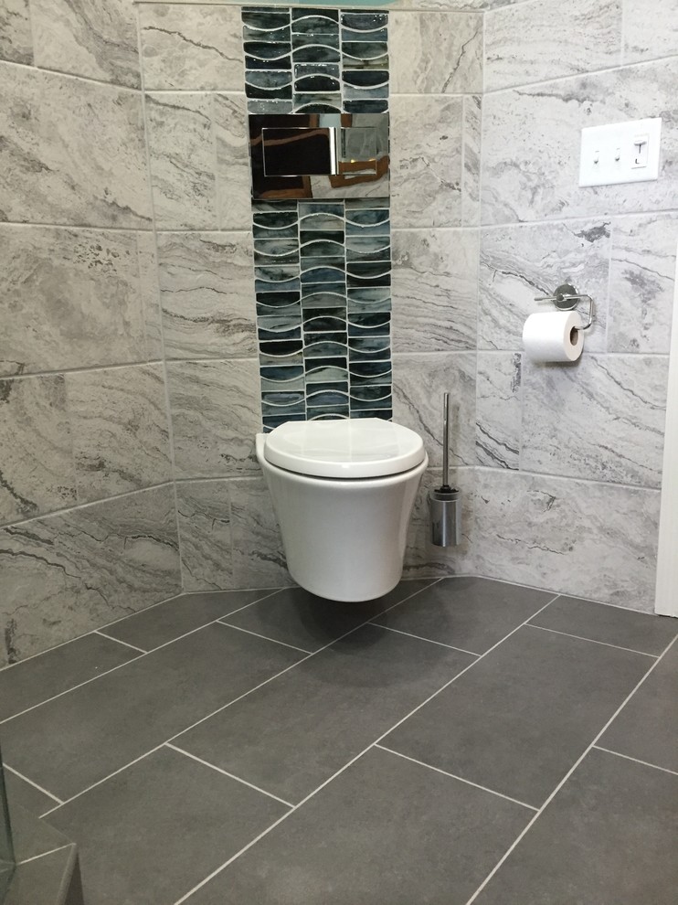 Mid-sized trendy slate floor corner shower photo in Other with medium tone wood cabinets, a one-piece toilet, blue walls, a vessel sink, granite countertops and a hinged shower door