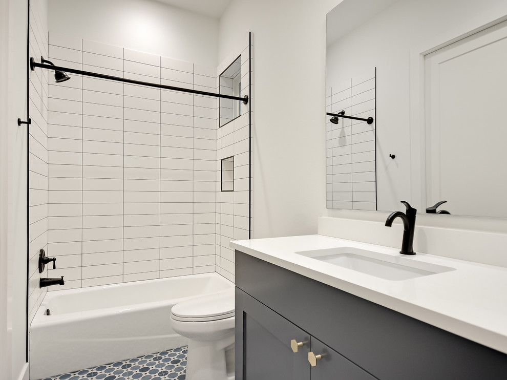 Example of a large cottage master ceramic tile ceramic tile and gray floor bathroom design in Austin with recessed-panel cabinets, white cabinets, an undermount tub, white walls, an undermount sink and quartz countertops