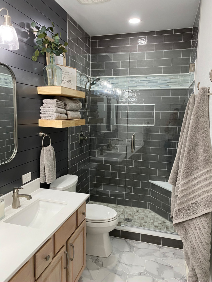 Example of a small farmhouse 3/4 gray tile and subway tile porcelain tile, gray floor, double-sink and shiplap wall bathroom design in Dallas with raised-panel cabinets, light wood cabinets, gray walls, an undermount sink, quartz countertops, a hinged shower door, white countertops and a built-in vanity
