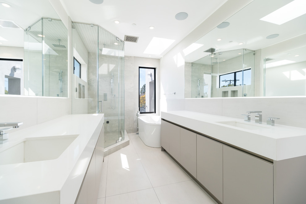 Example of a large trendy master beige tile and porcelain tile porcelain tile and beige floor bathroom design in Los Angeles with flat-panel cabinets, beige cabinets, a one-piece toilet, beige walls, an undermount sink, quartzite countertops, a hinged shower door and white countertops