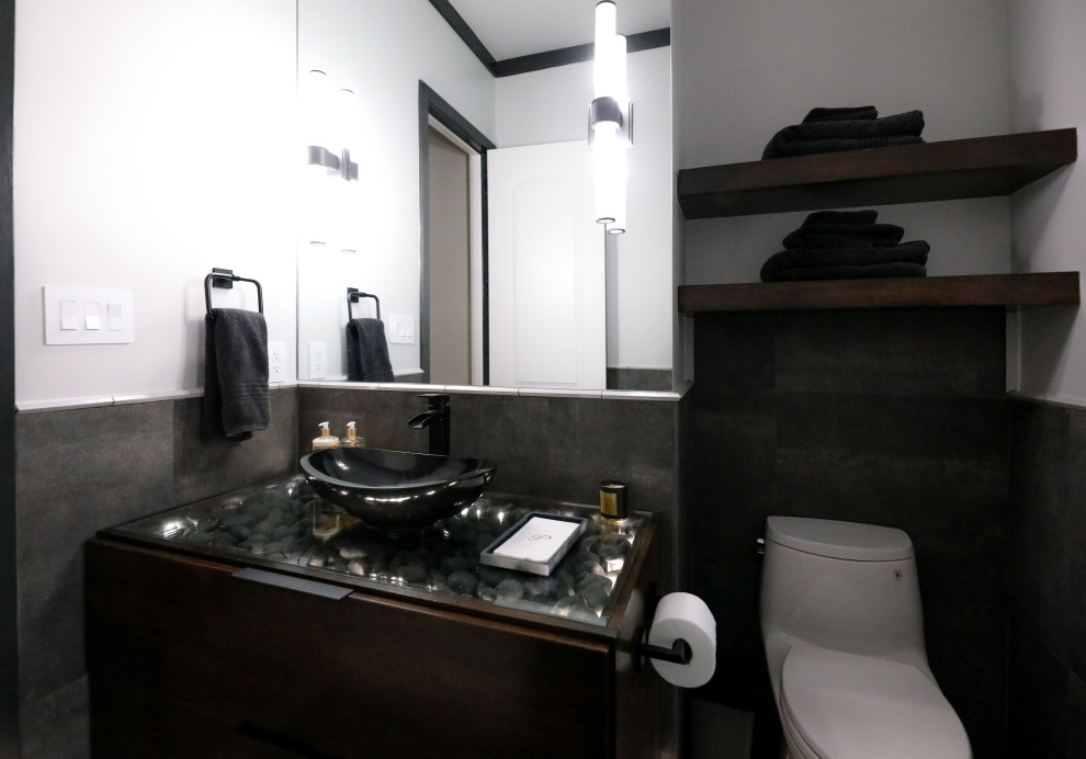 Foto på ett mellanstort funkis badrum, med skåp i mörkt trä, klinkergolv i porslin, ett fristående handfat och bänkskiva i glas