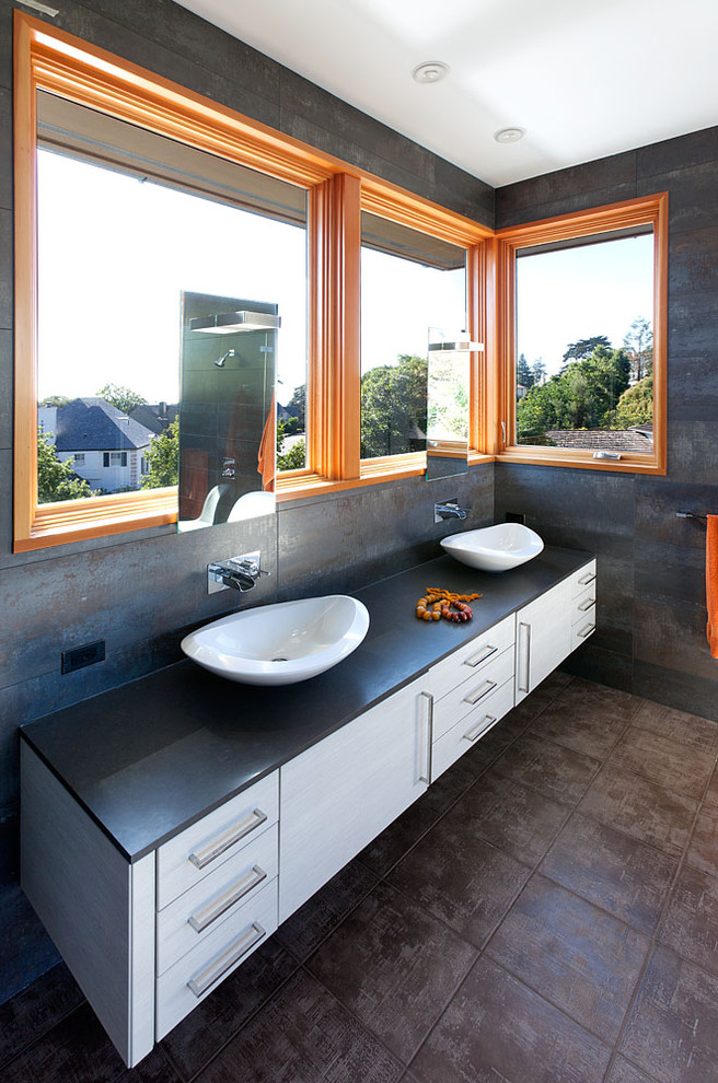 This is an example of a contemporary bathroom in San Francisco with a vessel sink and grey tiles.