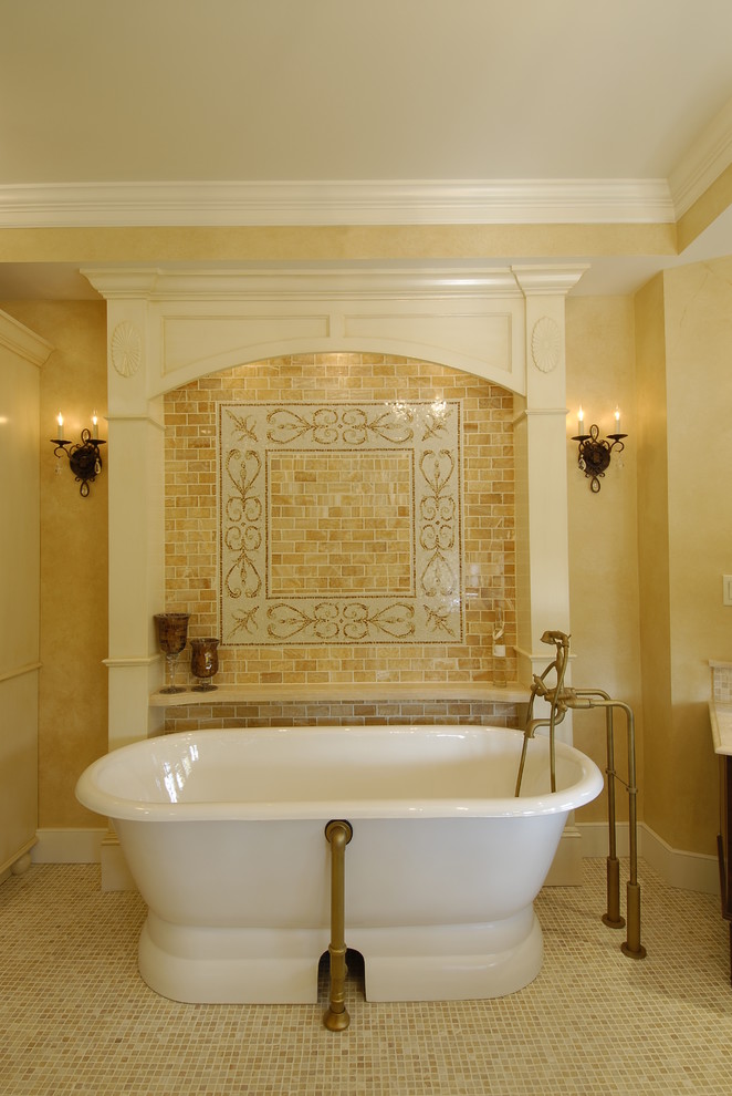Источник вдохновения для домашнего уюта: главная ванная комната среднего размера в средиземноморском стиле с врезной раковиной, фасадами с выступающей филенкой, темными деревянными фасадами, столешницей из известняка, отдельно стоящей ванной, бежевой плиткой, керамогранитной плиткой, желтыми стенами и полом из мозаичной плитки