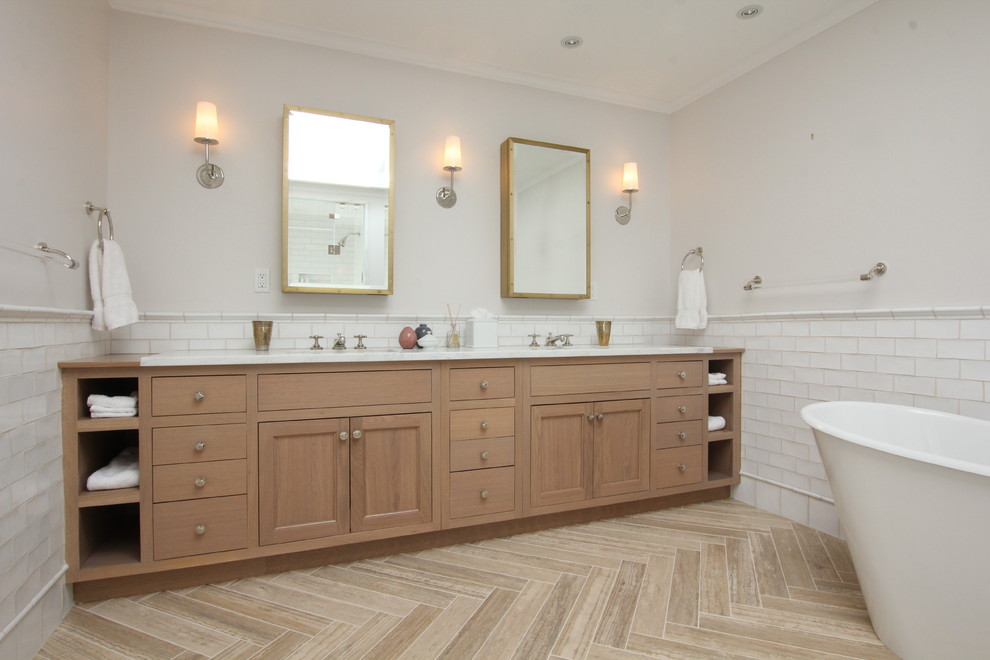 Inspiration for a large timeless master white tile and subway tile travertine floor bathroom remodel in New York with flat-panel cabinets, light wood cabinets, white walls, an undermount sink and marble countertops