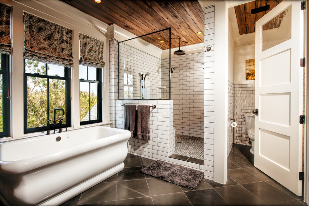Inspiration for a large timeless master white tile and subway tile porcelain tile and gray floor bathroom remodel in Charleston with a two-piece toilet, furniture-like cabinets, light wood cabinets, white walls and a console sink