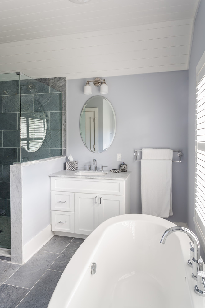 Mid-sized trendy master ceramic tile bathroom photo in New York with shaker cabinets, white cabinets, a two-piece toilet, purple walls, an undermount sink and marble countertops