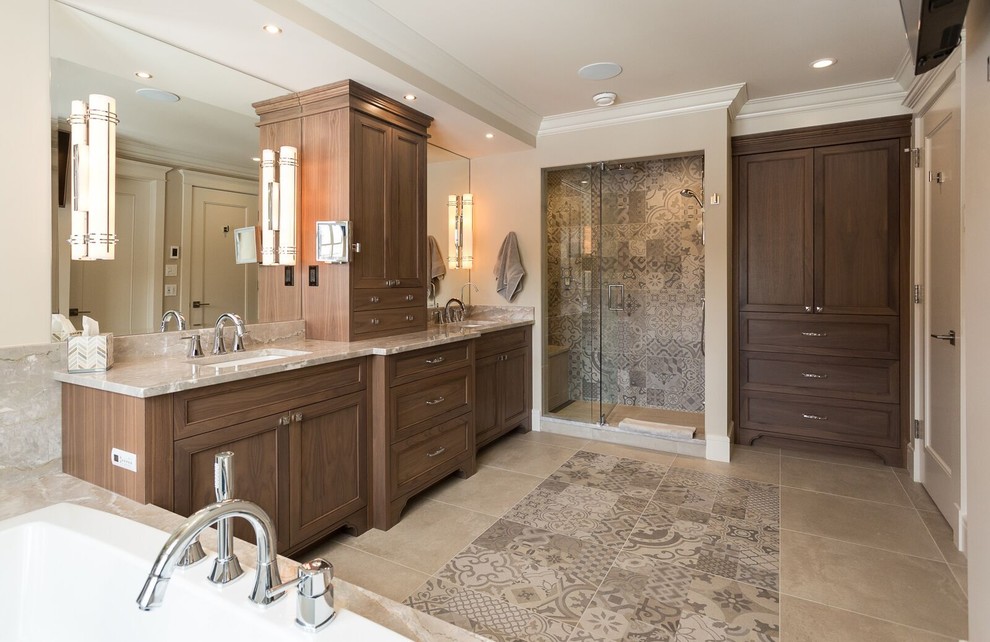 Inspiration for a large timeless master multicolored tile and ceramic tile ceramic tile bathroom remodel in Calgary with recessed-panel cabinets, dark wood cabinets, beige walls, an undermount sink and marble countertops