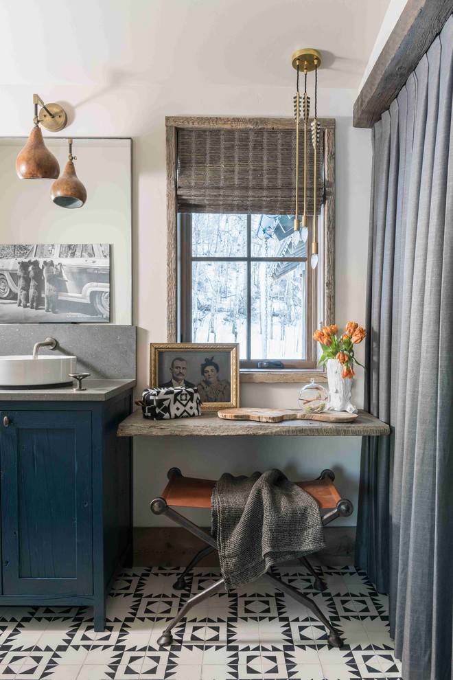 Inspiration for a rustic bathroom in Other with shaker cabinets, blue cabinets, white walls, cement flooring, a vessel sink, multi-coloured floors and grey worktops.