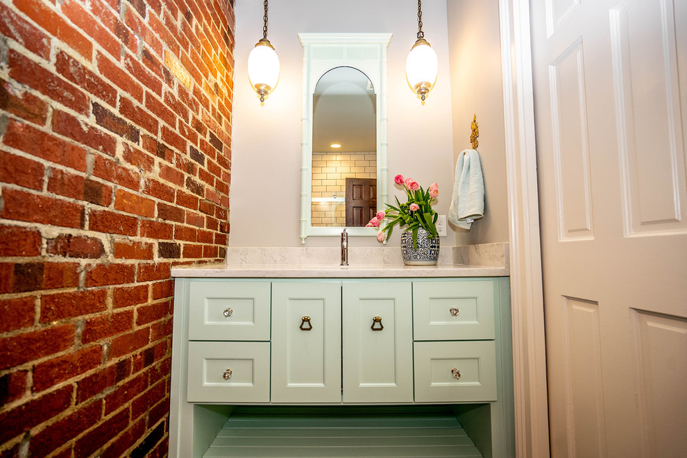 Inspiration for a medium sized eclectic family bathroom in Atlanta with shaker cabinets, green cabinets, an alcove shower, a one-piece toilet, white tiles, white walls, porcelain flooring, a submerged sink, engineered stone worktops, grey floors, a sliding door, white worktops and ceramic tiles.