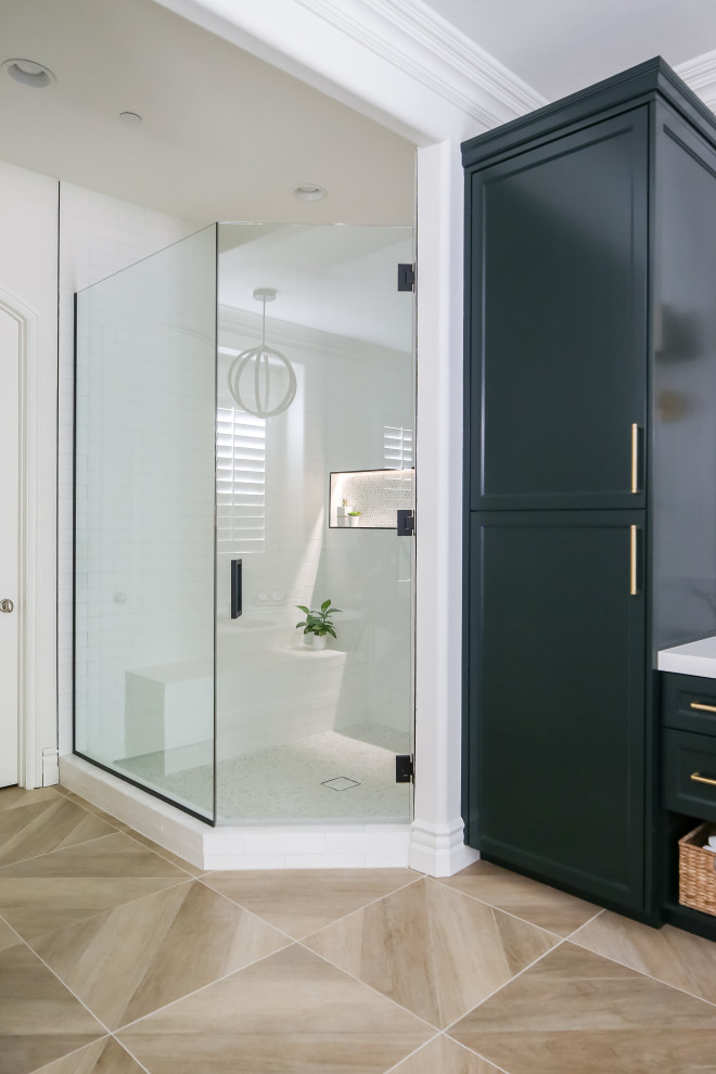Bathroom in Orange County with green cabinets and a corner shower.