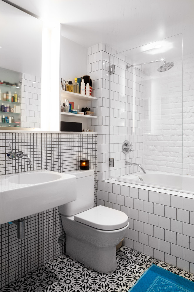 Inspiration for a small modern 3/4 white tile and mosaic tile porcelain tile and black floor bathroom remodel in New York with open cabinets, white cabinets, a one-piece toilet, white walls and a wall-mount sink