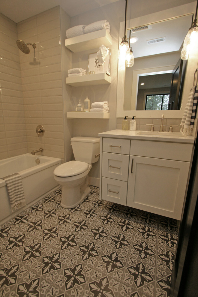 Идея дизайна: маленькая ванная комната в стиле неоклассика (современная классика) с фасадами в стиле шейкер, белыми фасадами, ванной в нише, душем в нише, раздельным унитазом, серой плиткой, керамогранитной плиткой, серыми стенами, полом из керамогранита, душевой кабиной, врезной раковиной, столешницей из искусственного кварца, серым полом и шторкой для ванной для на участке и в саду